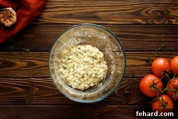 Cottage cheese mixed with egg, seasonings, and fresh parsley in a large bowl for the lasagna filling.