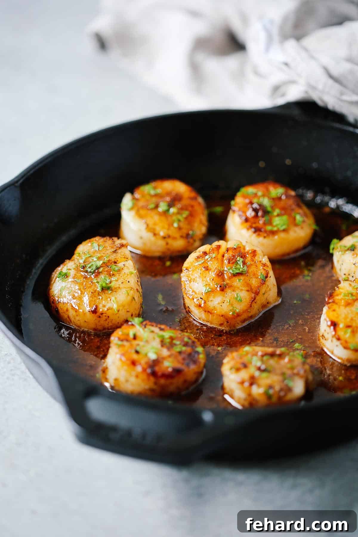 Pan-Seared Garlic Butter Scallops 4 close up of garlic butter scallops in a cast ion skillet