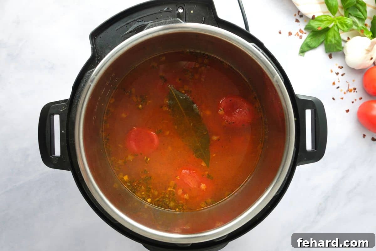 The Instant Pot's inner pot filled with vibrant, perfectly cooked tomato soup, indicating the successful completion of the pressure cooking and natural release phases, ready for the next steps.