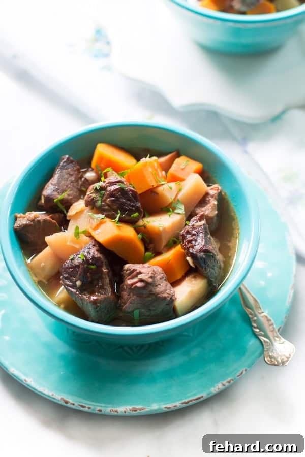 Delicious Slow Cooker Beef Stew with Turnip and Carrots - A comforting, healthy, and easy meal. A close-up of slow cooker beef stew generously filled with tender turnip and carrot pieces.