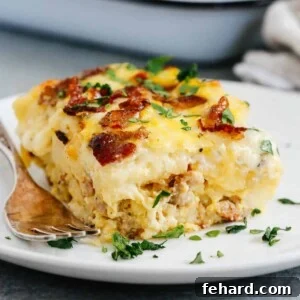 Close up of a slice of Sausage and Potato Breakfast Casserole, garnished with fresh herbs, ready to be served.