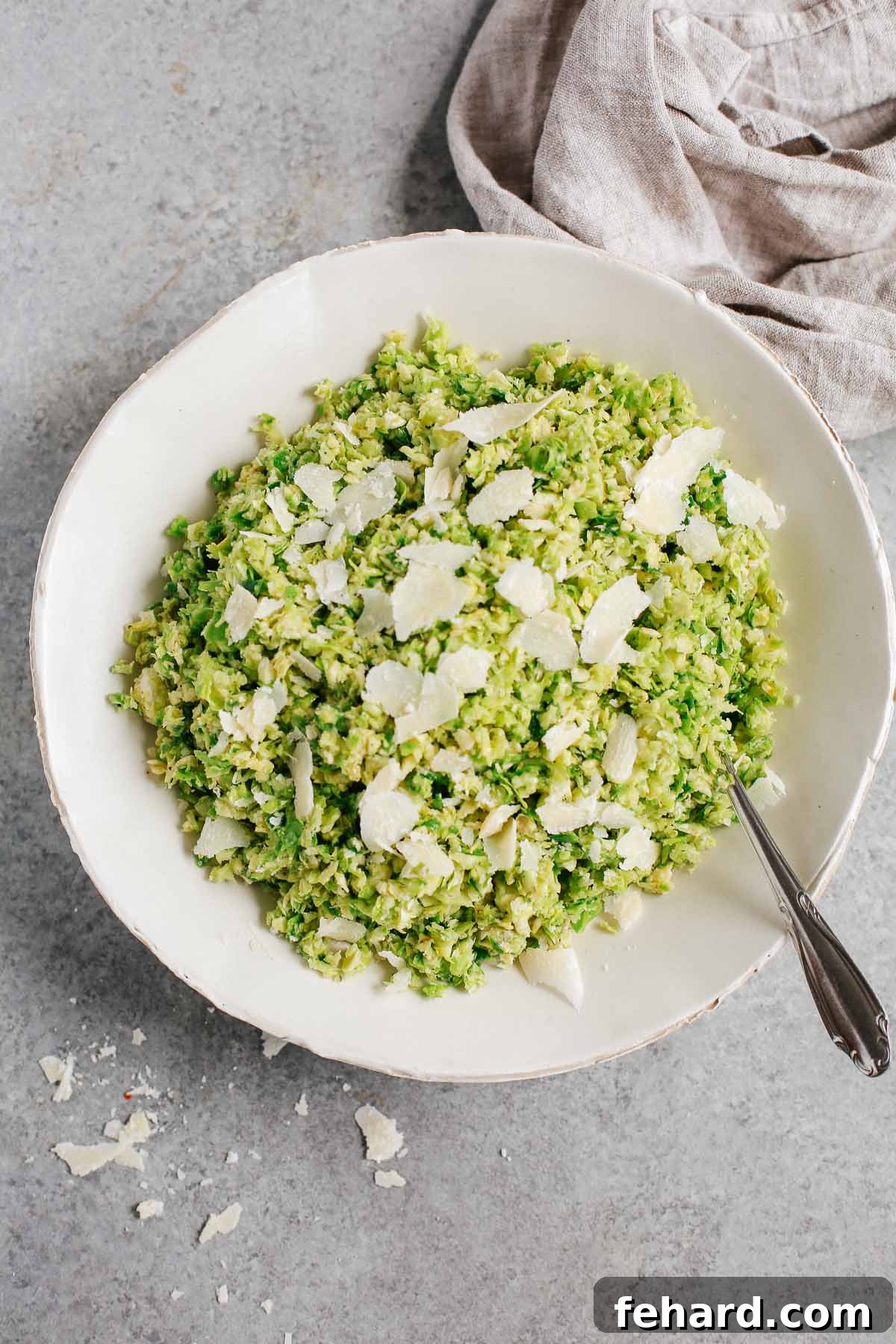 overhead view of a plate of Parmesan Brussels Sprouts Salad, crisp and green