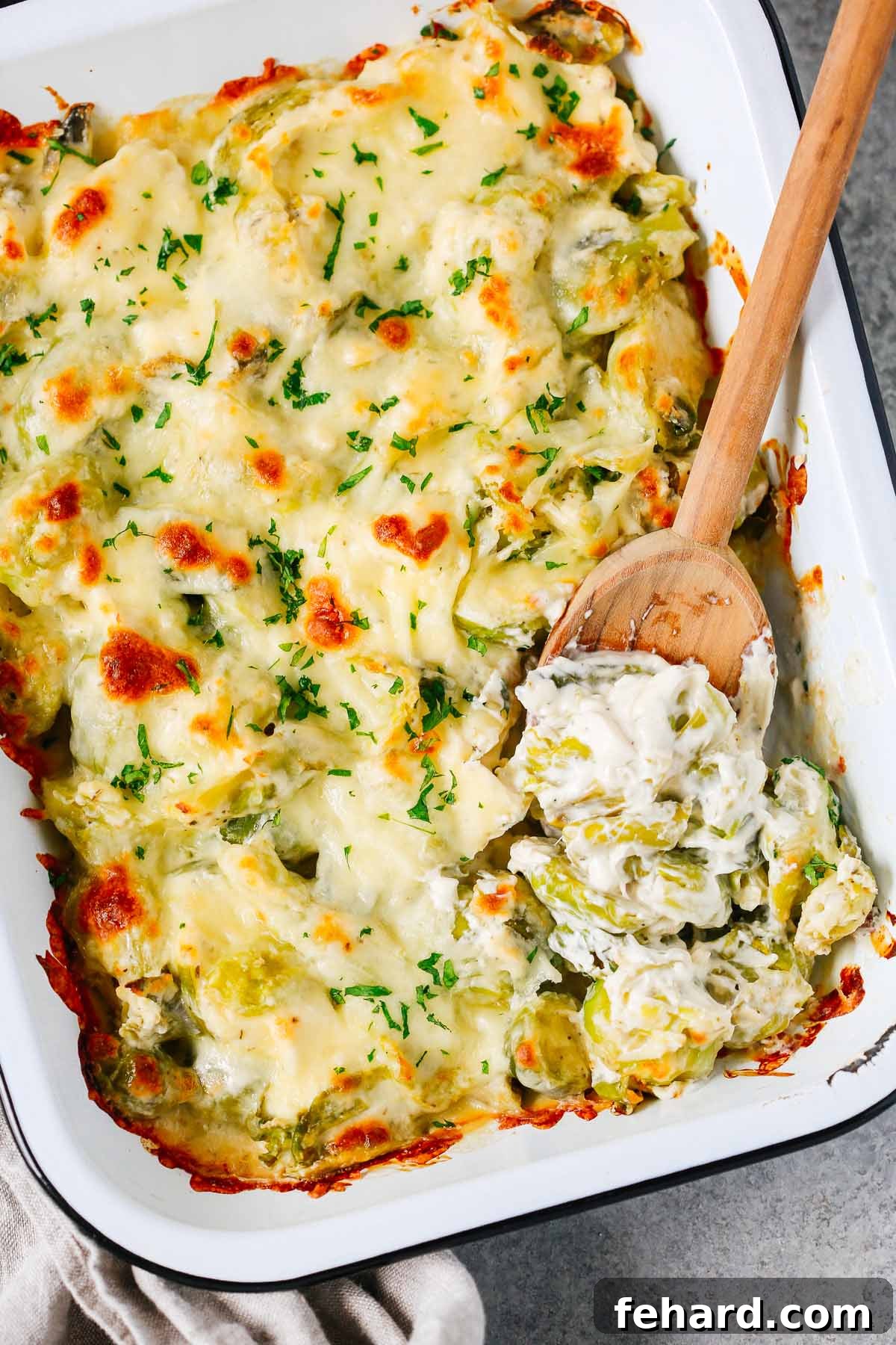 Close up of Brussels Sprouts Casserole Recipe, showing melted cheese and tender sprouts.