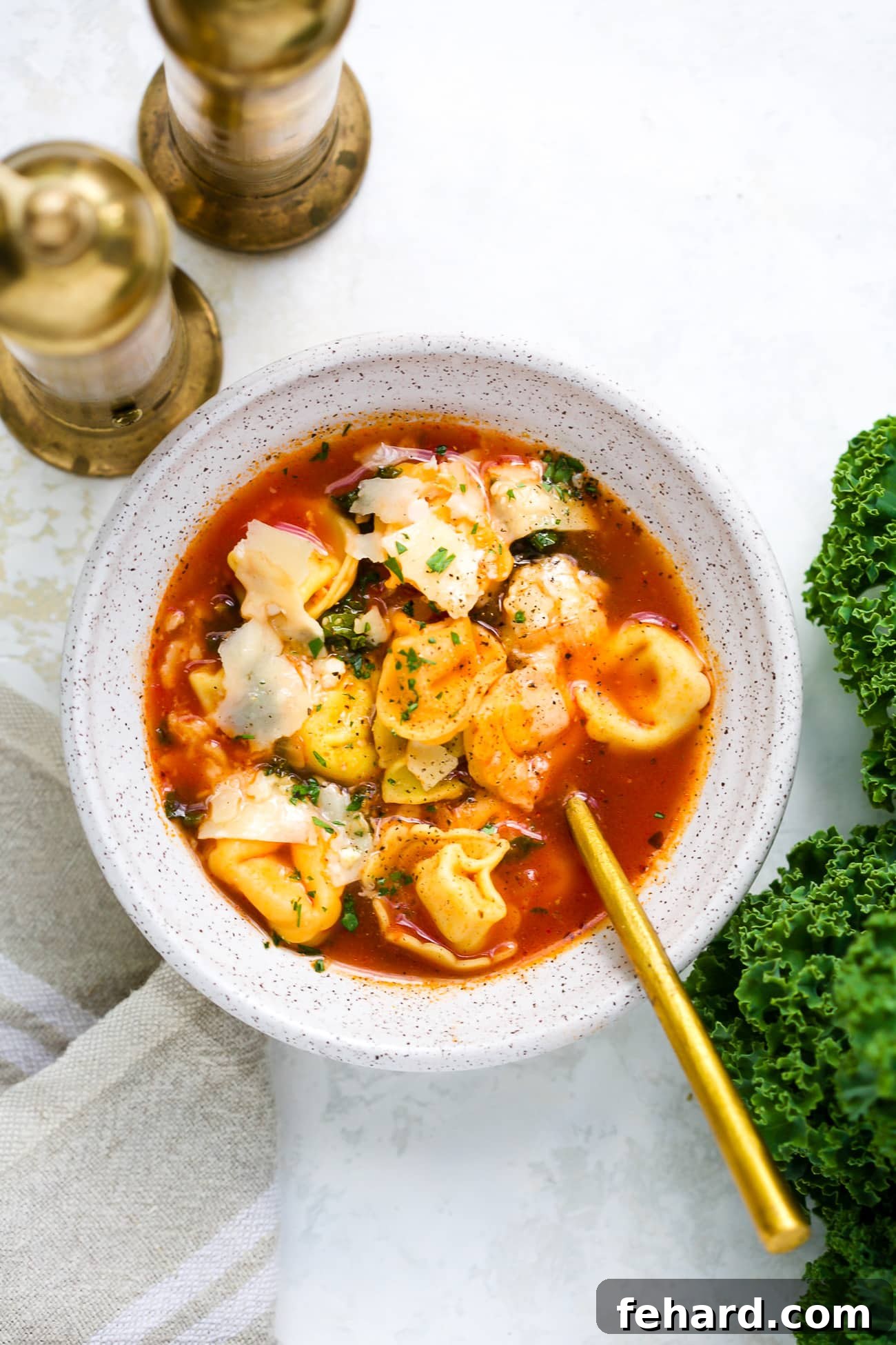 Another perspective of a bowl of delicious kale tortellini soup, ready to be enjoyed on a cozy evening.