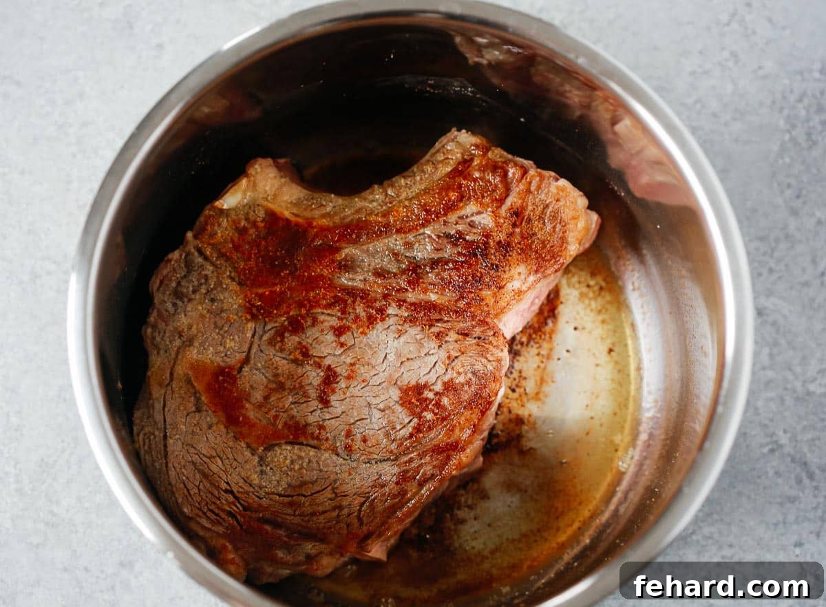 Ultimate Instant Pot Pot Roast 3 Chuck roast seared in a pressure cooker.