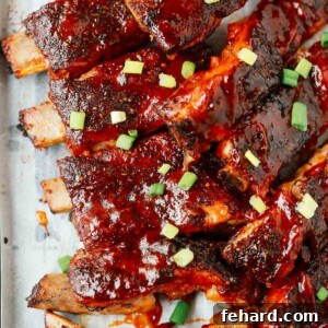 Fall-Off-The-Bone Slow Cooker Ribs 8 A close up of ribs on a wooden cutting board