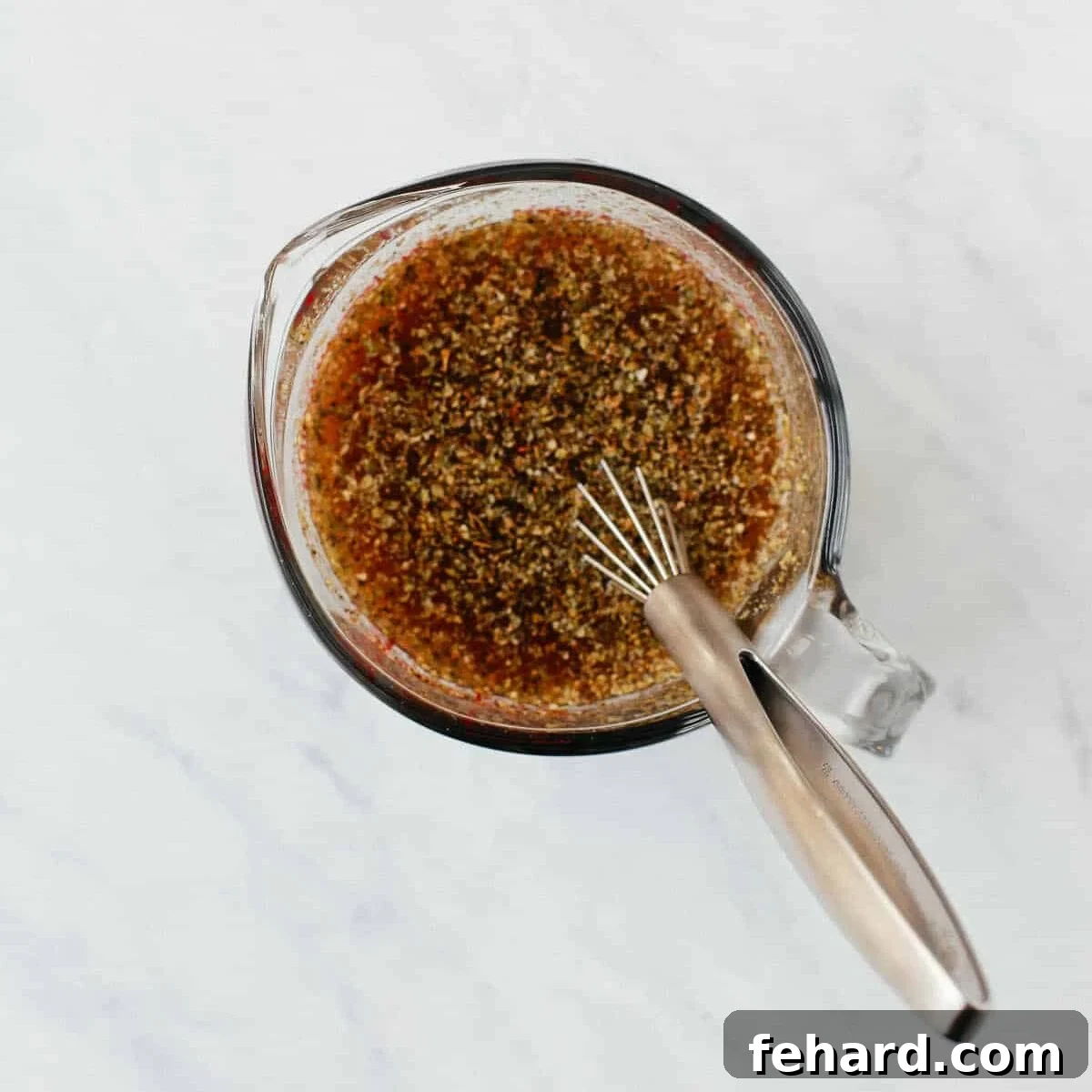 overhead view of a glass cup with broth inside