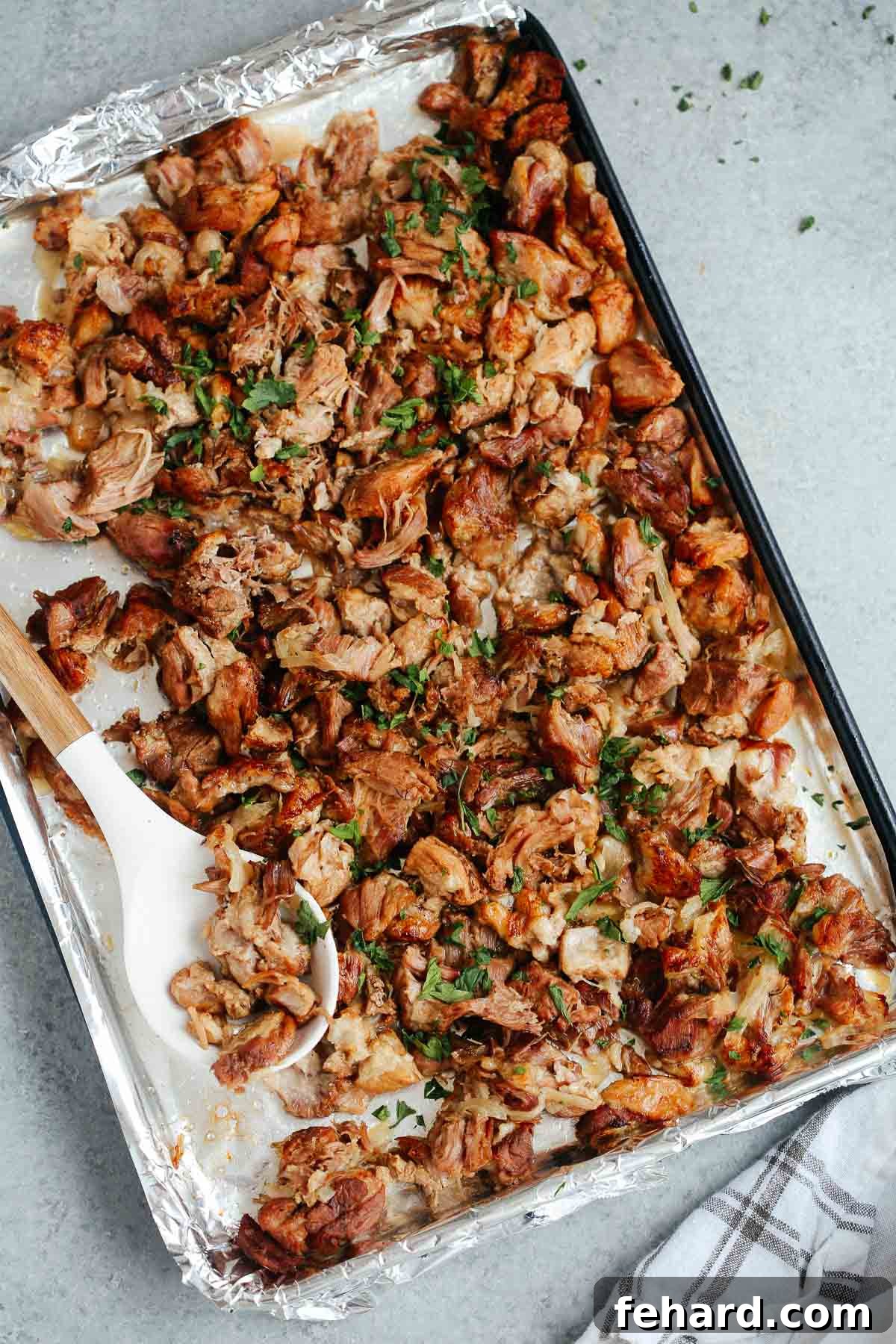 Instant Pot carnitas transfered to a sheet pan to broil in the oven.