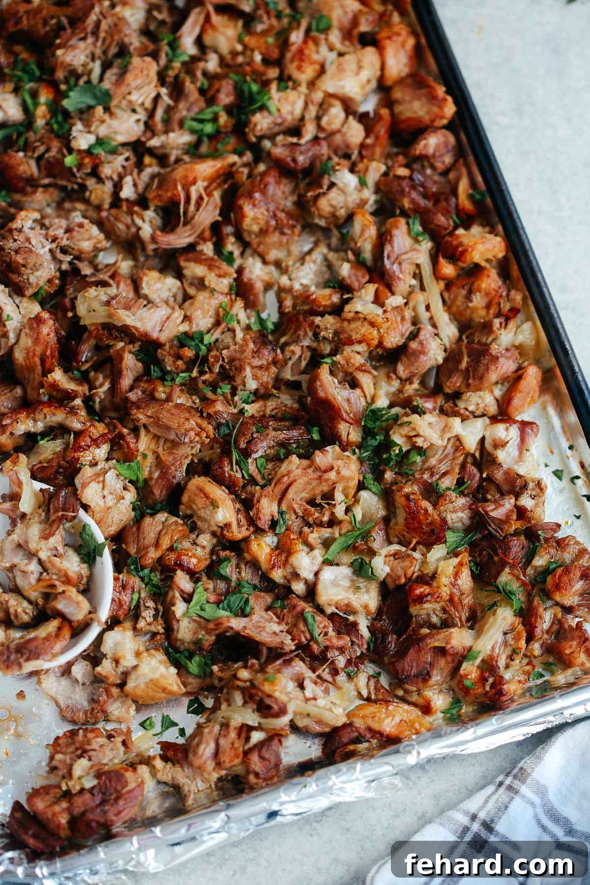 Crispy Instant Pot carnitas on a sheet pan, topped with garnish.