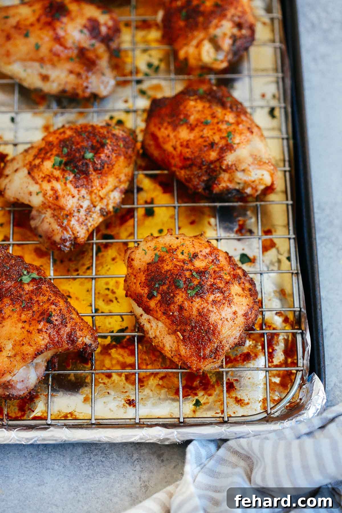 A vibrant platter of multiple baked paprika chicken thighs, perfectly golden and crispy, garnished with fresh herbs, ready to be served alongside complementary side dishes.