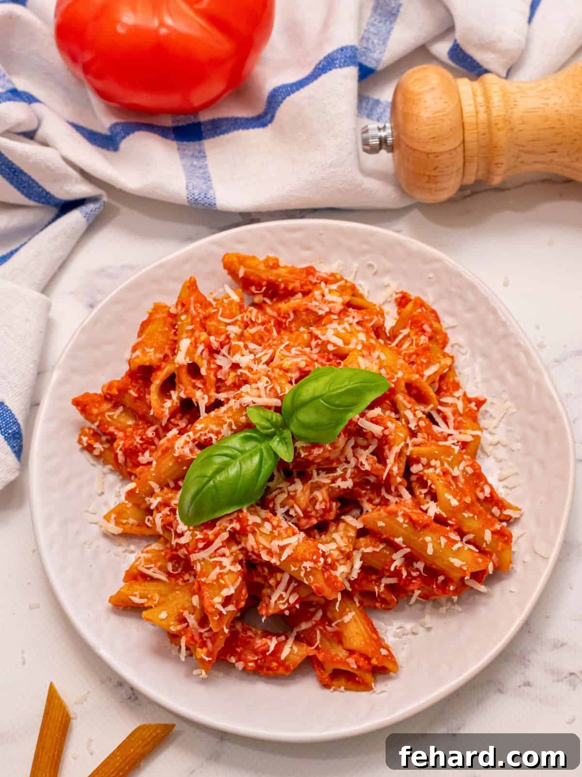 Crockpot Pasta Recipe: Easy Slow Cooker Baked Ziti Slow cooker ziti made with cottage cheese and mozzarella served on a white plate, garnished with fresh basil.