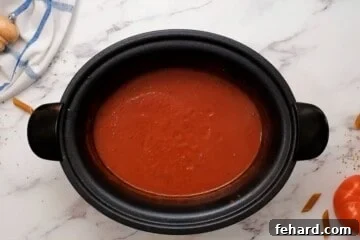 Ingredients for homemade spaghetti sauce in crockpot after slow cooking but before adding pasta.