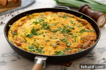 Baked Frittata with potatoes and bacon in oven-safe skillet.
