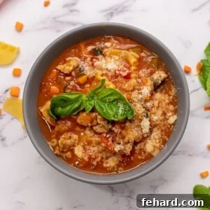 Lasagna Soup in gray bowl topped with cheese.