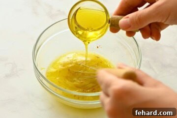 Olive Oil being emulsified into dressing for greek salad.
