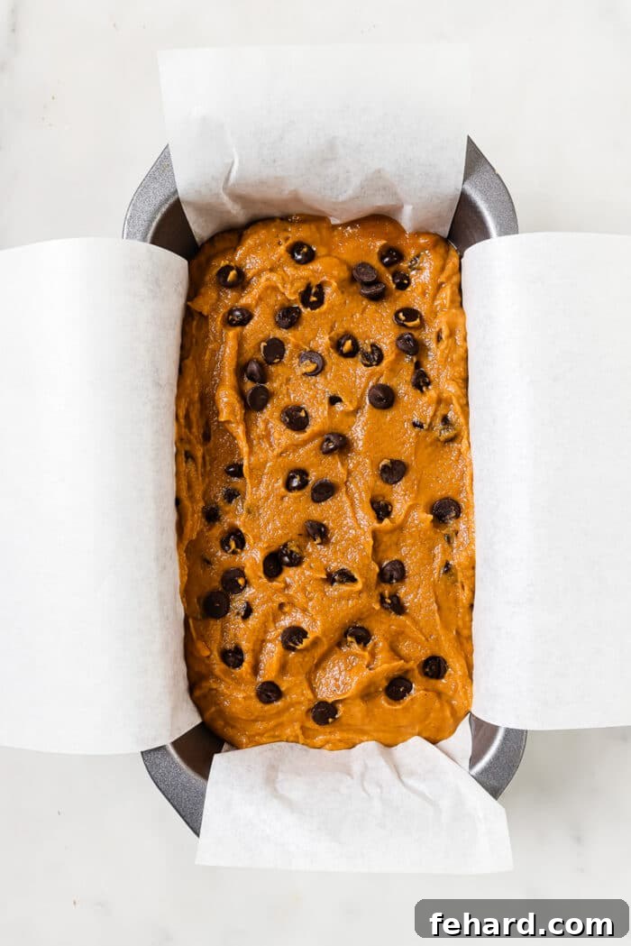 Cozy Autumn Pumpkin Chocolate Chip Loaf 8 Pumpkin chocolate chip bread batter in a loaf pan.