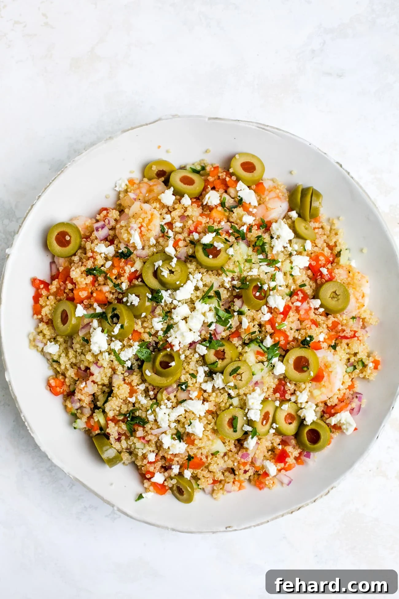 Vibrant Shrimp Quinoa Bowl 9 Overhead view of shrimp quinoa salad in a white bowl.
