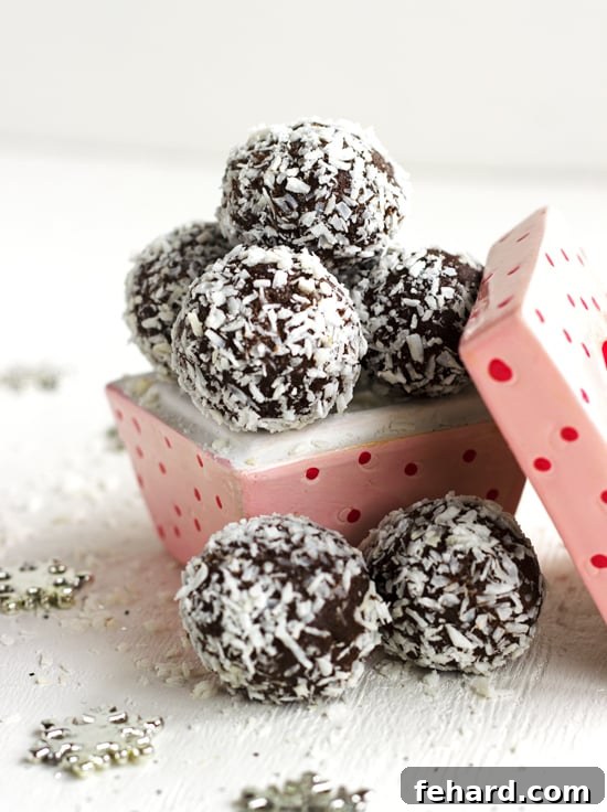 Gluten-free Chocolate Truffles coated in shredded coconut in a pink serving dish with red polka dots. Rich, no-bake truffles with wholesome ingredients for a guilt-free treat.
