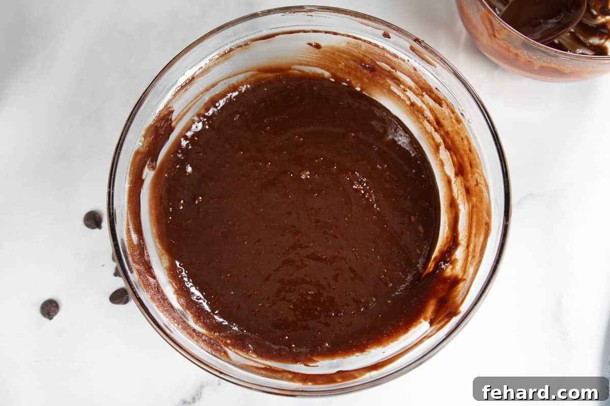 Lava Cake Recipe Molten lava cake batter in clear mixing bowl.