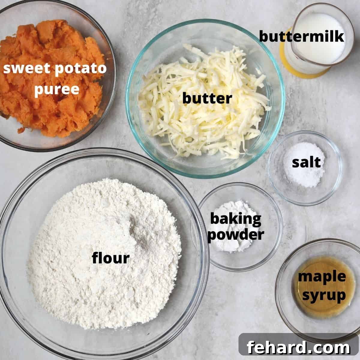 Various ingredients for sweet potato biscuits, including flour, butter, sweet potato puree, and buttermilk, neatly arranged and labeled.