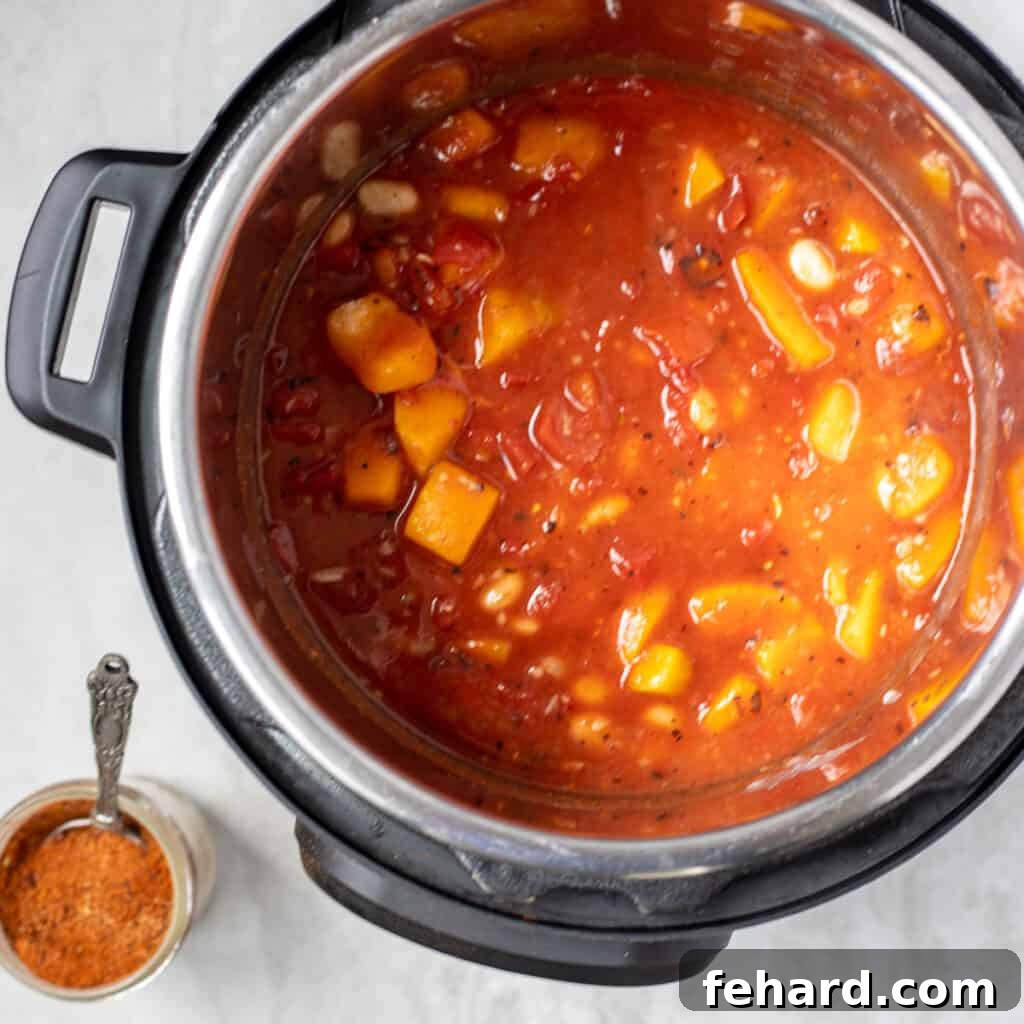 Butternut Squash Chili inside an Instant Pot after pressure cooking, ready to be stirred and served.