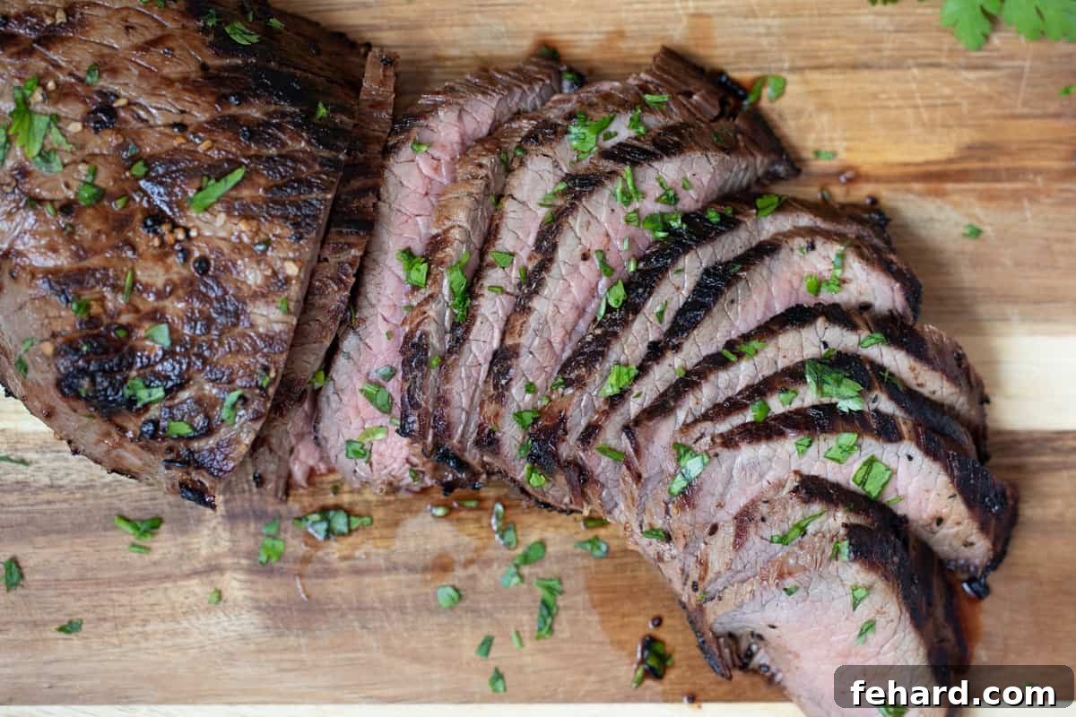 How to cook London Broil Thinly sliced London Broil, cut against the grain, arranged beautifully on a wooden cutting board and garnished with fresh chopped parsley.