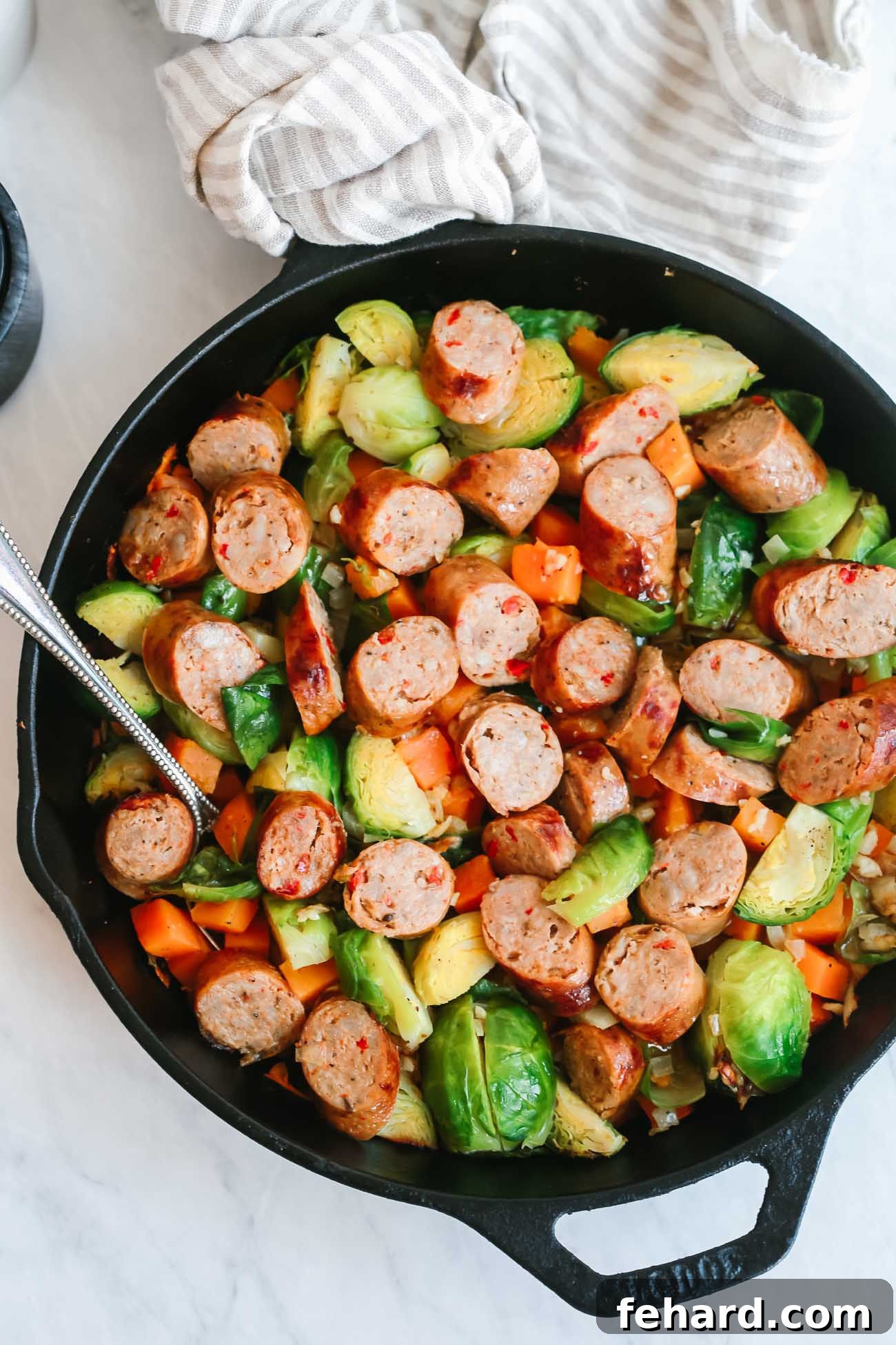 A close-up view of the finished sausage and Brussels sprouts skillet, showcasing the perfectly cooked ingredients.