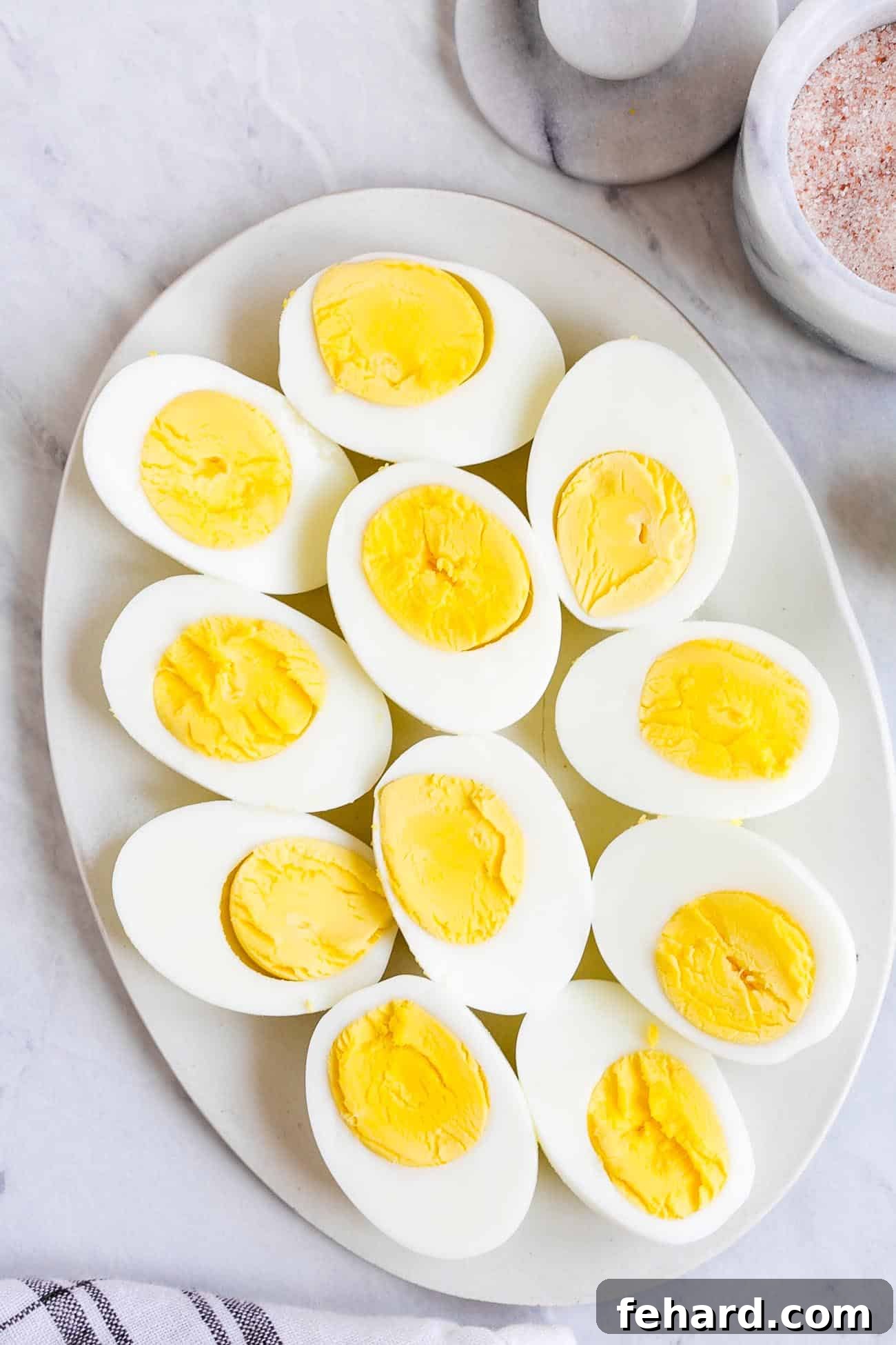 A platter of hard-boiled eggs cut in half, showcasing perfect yolks.
