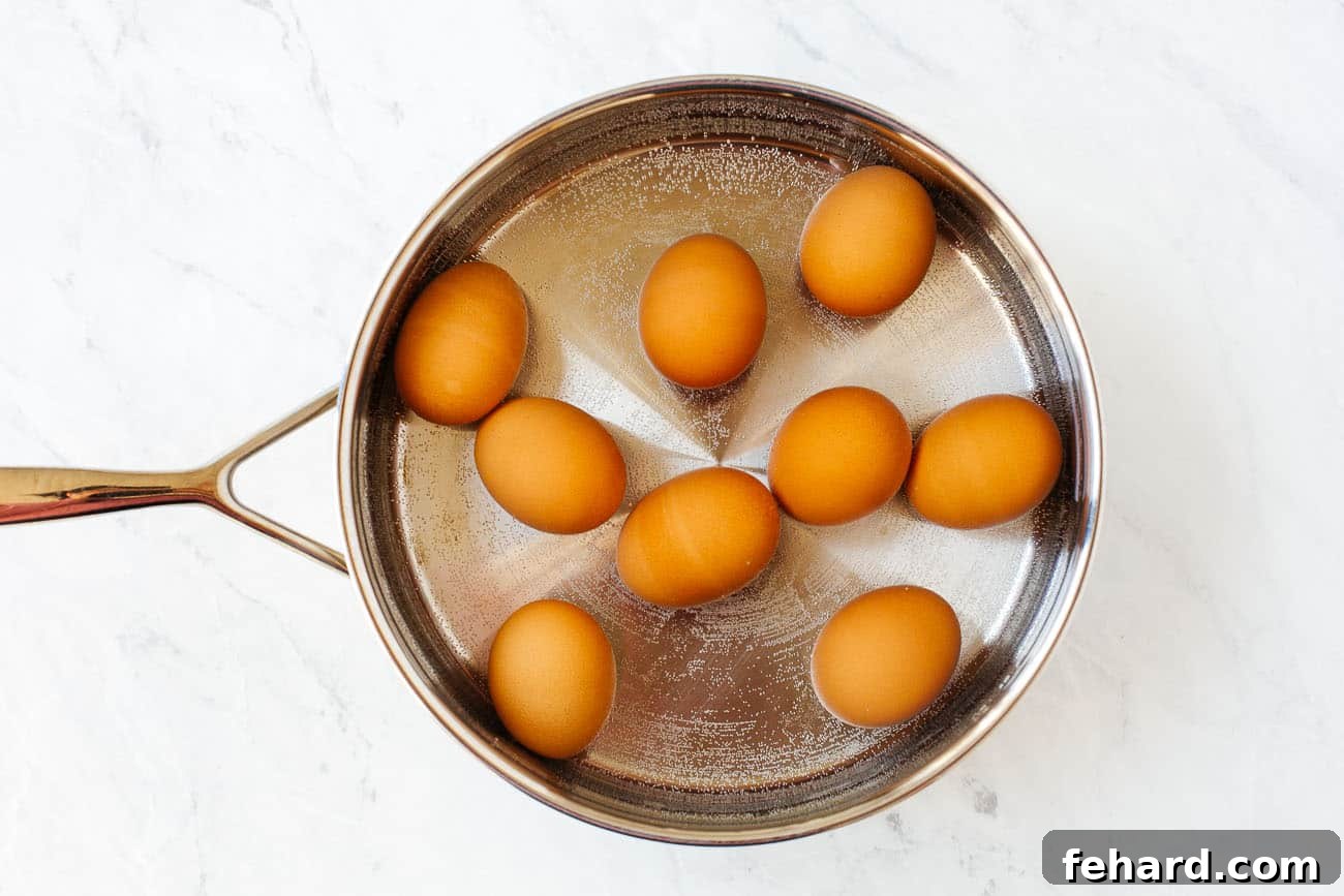 Eggs inside of a pot of water to be boiled.
