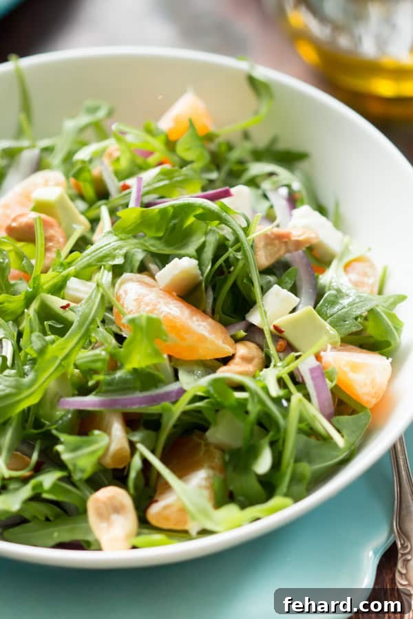 Fresh Clementine Arugula Salad Details Close-up of a vibrant Clementine Arugula Salad, highlighting the juicy clementine segments, fresh arugula, and crunchy cashews.