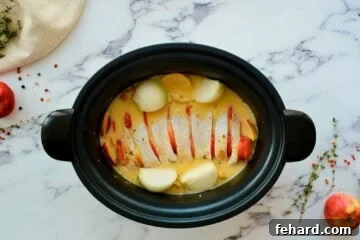 Pork loin roast with apples, onions, and mustard apple cider liquid.