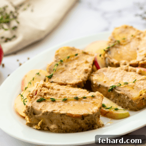 Sliced slow cooker pork roast on platter with thyme leaves.