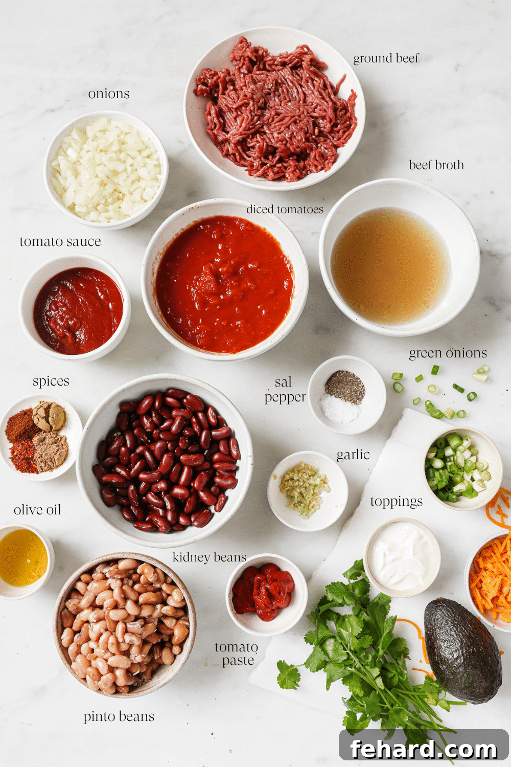 Set It and Forget It Chili 3 Individual bowls containing pre-measured ingredients like chopped onions, garlic, ground beef, beans, and spices, laid out neatly for cooking.