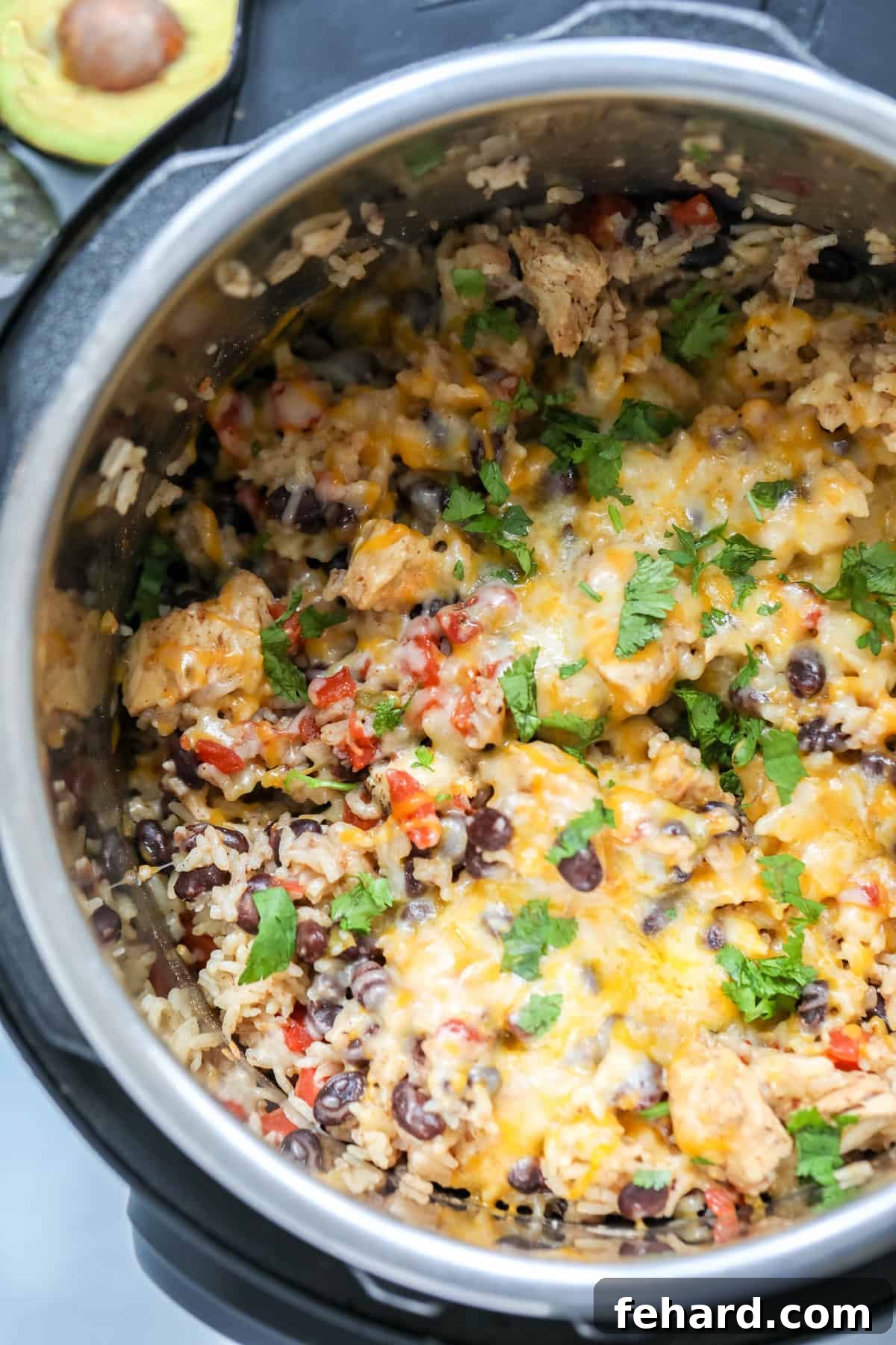 Instant Pot Chicken Burrito Bowl Recipe Delicious Instant Pot Burrito Bowl topped with melted cheese and fresh cilantro, ready to be served.