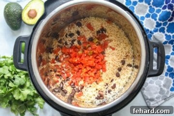 Effortless Instant Pot Burrito Bowls 8 Cooked rice and beans inside inner pot of Instant Pot.