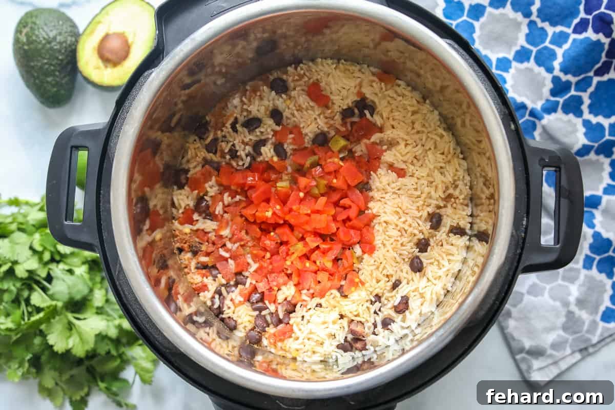 Effortless Instant Pot Burrito Bowls 3 Perfectly cooked rice and beans resting in the inner pot of the Instant Pot after cooking.
