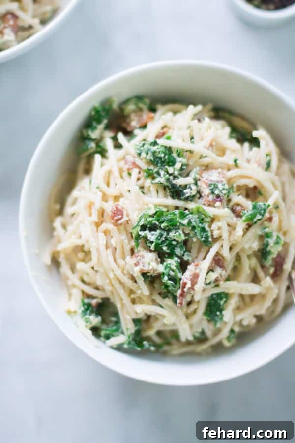 Make this classic Italian Carbonara recipe packed with eggs, cheese, bacon and kale. This is definitely a super easy, quick and rich recipe for dinner.