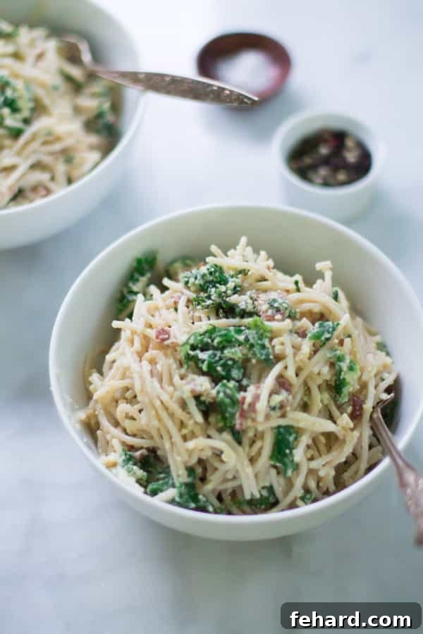 Make this classic Italian Carbonara recipe packed with eggs, cheese, bacon and kale. This is definitely a super easy, quick and rich recipe for dinner.