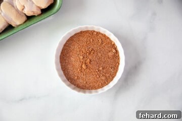 Mixed dry rub in a pristine white bowl, ready to season the chicken wings for a burst of flavor.