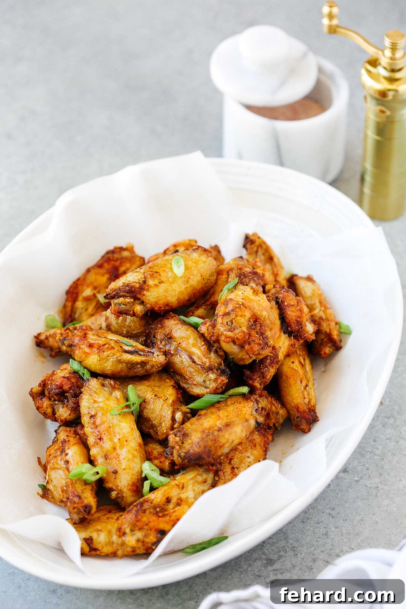 close-up of air fryer chicken wings in a white bowl