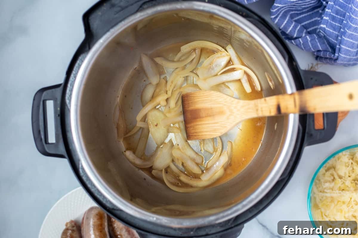 Showing the process of sautéing sliced onion in an Instant Pot for a bratwurst recipe. 