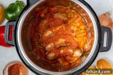 Peppers, onions, and sausages in tomato sauce in instant pot.
