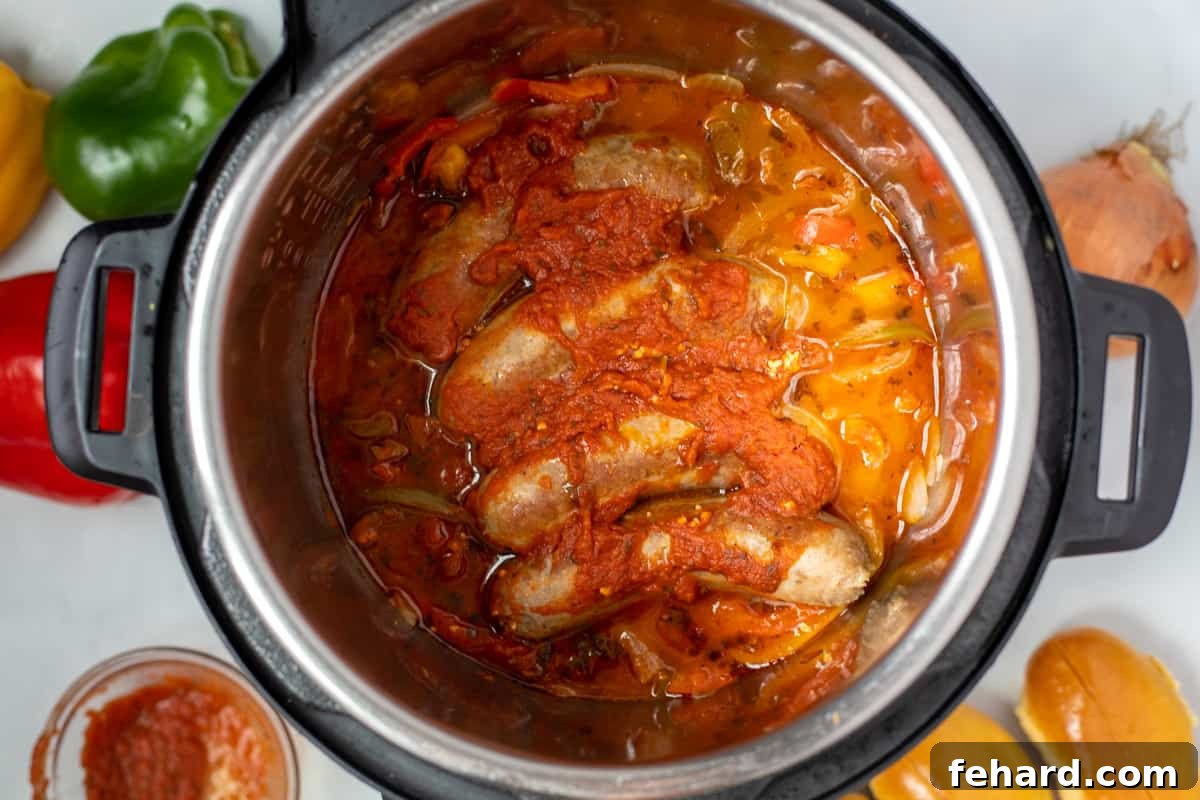 Peppers, onions, and sausages in tomato sauce in instant pot. 