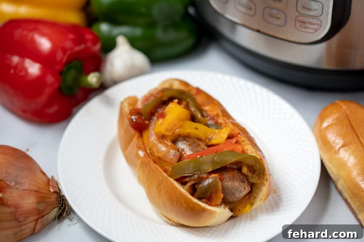 Italian Sausage topped with peppers, onions, on hoagie bun next to instant pot. 
