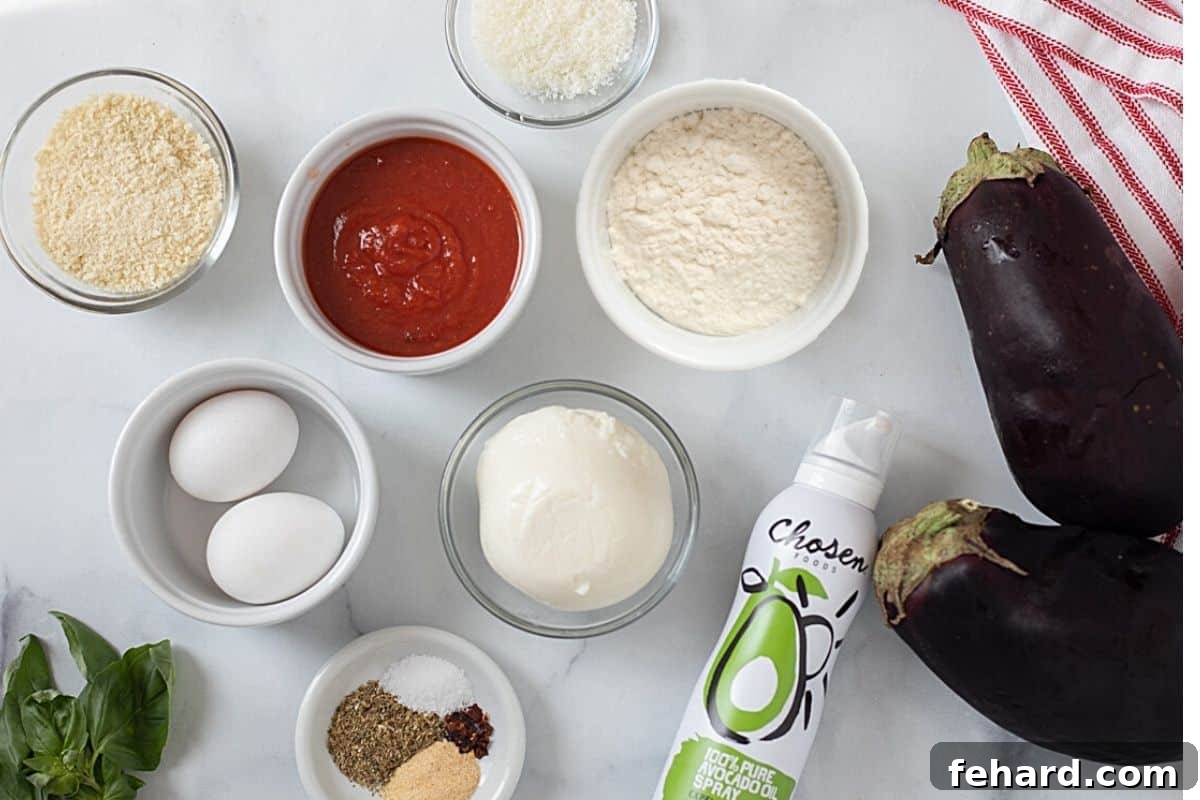 Assortment of fresh ingredients for Air Fryer Eggplant Parmesan on a kitchen counter: eggplant, panko breadcrumbs, parmesan cheese, mozzarella, marinara, and cooking spray.