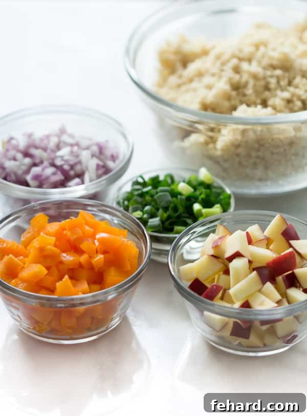 Close-up view of a vibrant couscous salad with a medley of finely chopped vegetables and fresh herbs, ready to be mixed with a zesty vinaigrette.