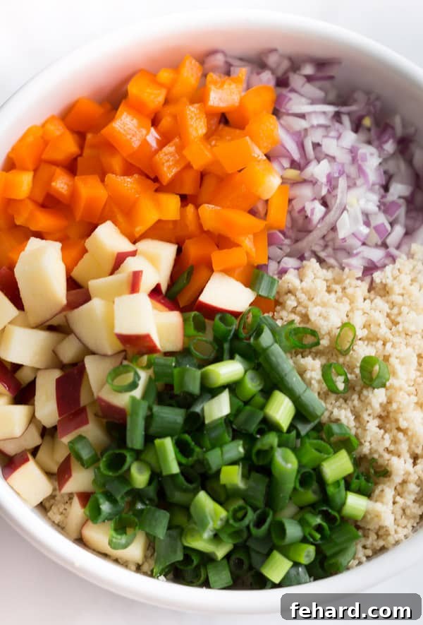 A close-up shot of the finished easy couscous salad, beautifully plated and garnished with fresh parsley, ready to be served and savored.