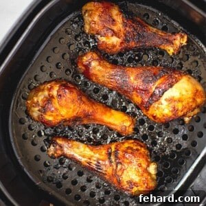 Air Fried Chicken Legs in basket of air fryer.