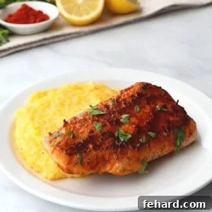 Blackened Mahi Mahi on plate served next to cheesy grits.