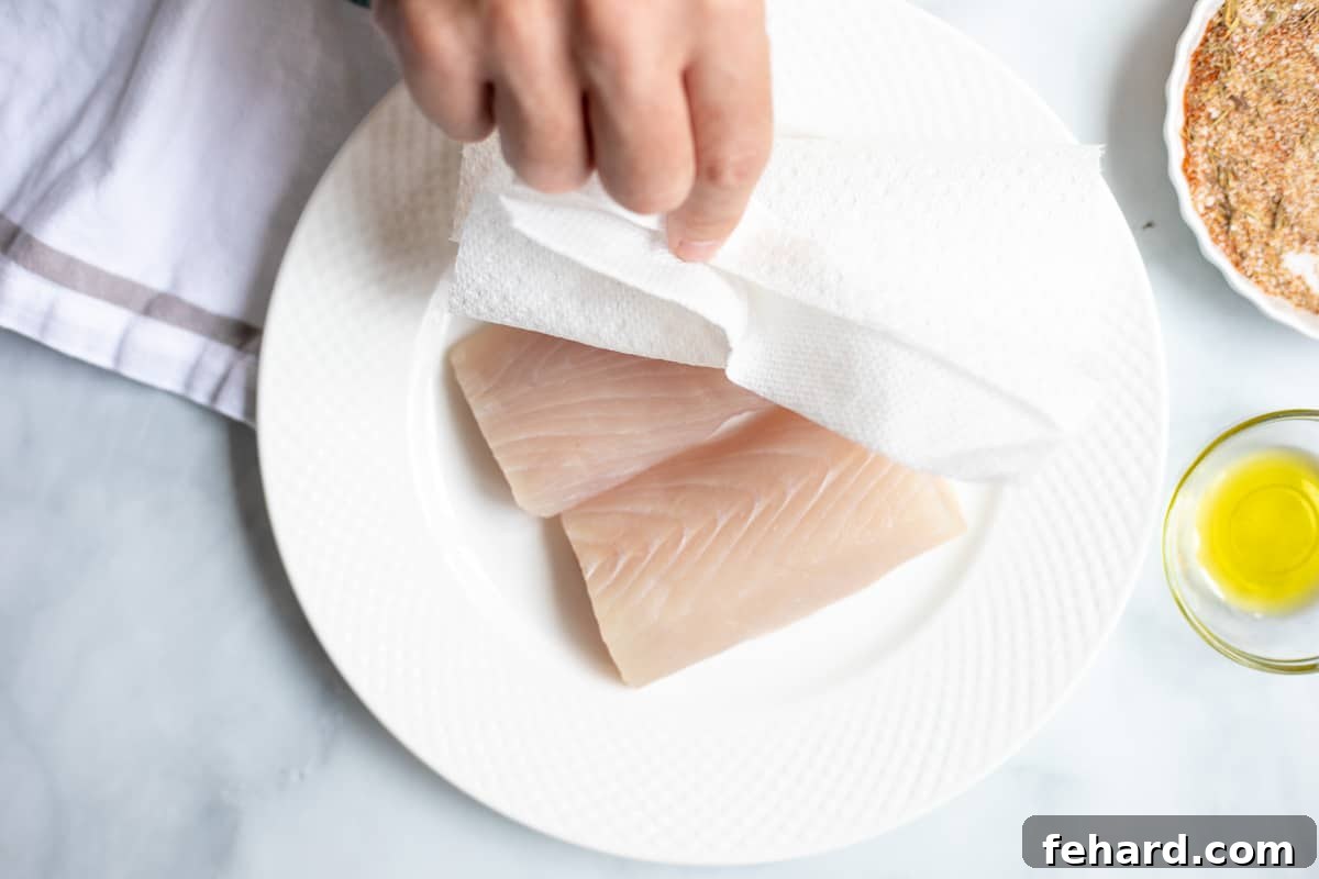 Paper towel drying mahi mahi fillets.